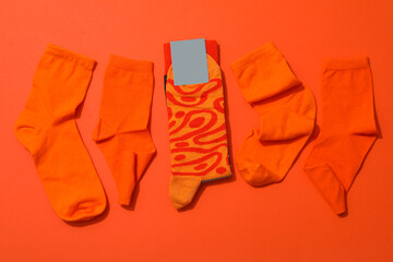 Socks with blank label on orange background