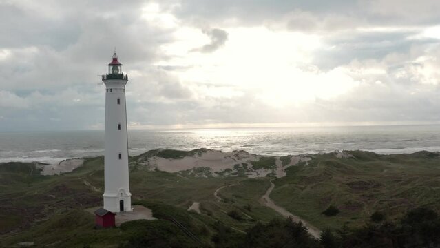 Aerial footage of a lighthouse near the shore on the western coast of Jutland, Denmark.