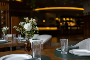 Table decoration with flowers. Modern restaurant design