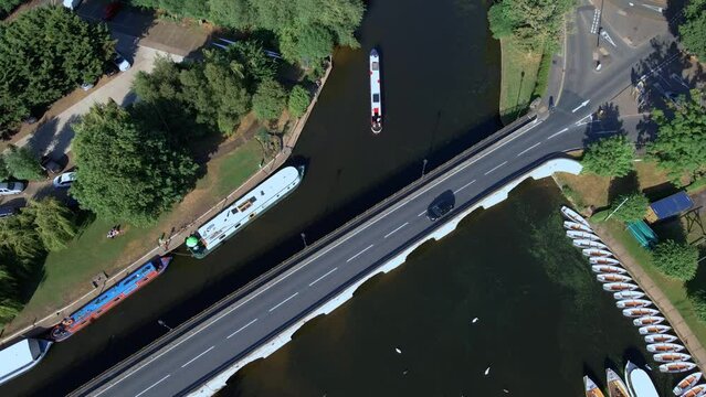 Aerial view tracking vehicle driving over Clapton historical archway canal bridge, England