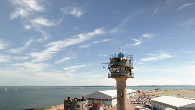 NCI Calshot Tower Lookout Station With Rotating Marine Radar On Top Overlooking Coastal Sea At Daytime In Calshot, UK. orbiting shot