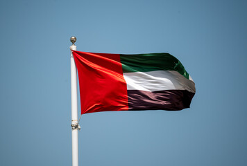 Fototapeta na wymiar United Arab Emirates national flag cloth fabric waving on sky. UAE national flag