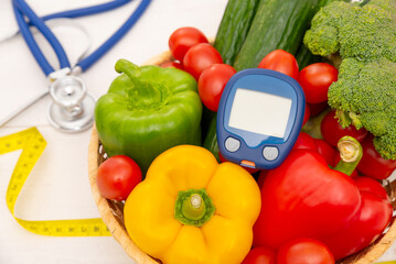 Glucometer and vegetables - diabetes concept