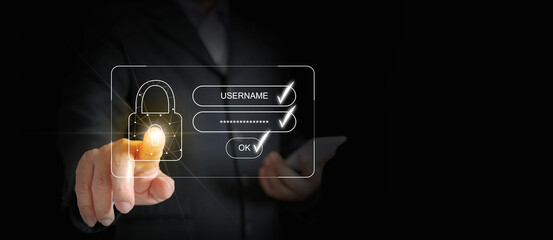 A businessman's finger tapping or activating a virtual digital padlock for safe online account access, after entering his username and password. Cybersecurity.