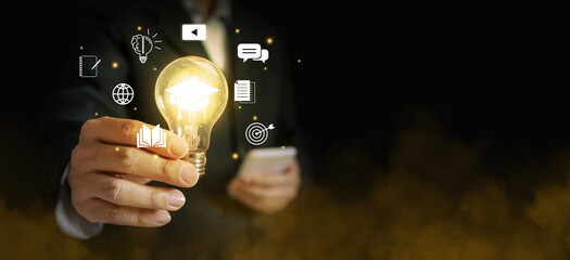 Hand of a businessman holding a glowing lightbulb out of foggy environment. Symbolizing his innovative and new ideas.