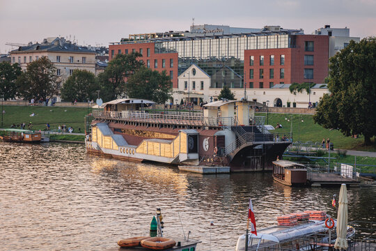 Krakow, Poland - August 23, 2022: Stefan Batory restaurant boat and Sheraton Hotel over Vitula River in Krakow