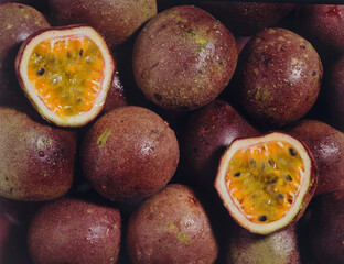 whole passion fruit and one cut in half - natural background

