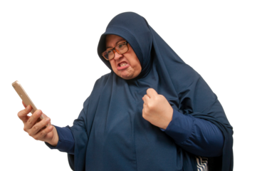 A big size Asian Muslim woman staring and texting with an upset and angry expression on her face.
