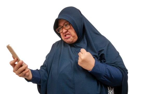 A big size Asian Muslim woman staring and texting with an upset and angry expression on her face.