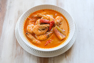 tom yum kung, spicy Thai tom yum soup in white bowl
