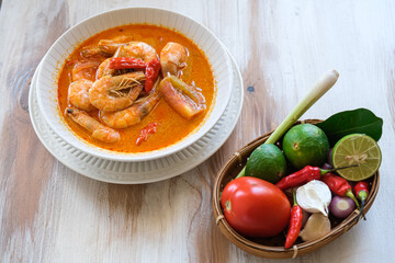 tom yum kung, spicy Thai tom yum soup in white bowl
