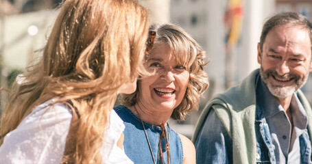 Smiling mature friends walking on street