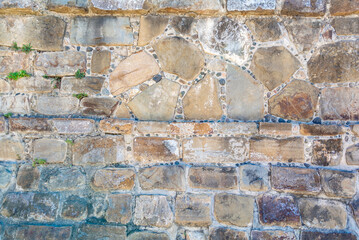 Old stone walll made of rocks and cement