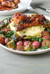 Chicken with roasted vegetables and mashed potatoes on a plate