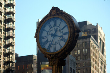 Fototapeta na wymiar Iron golden vintage clock in downtown Manhattan in New York City