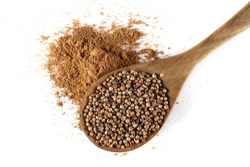 Coriander ground pile and grains in wooden spoon isolated on white, top view 