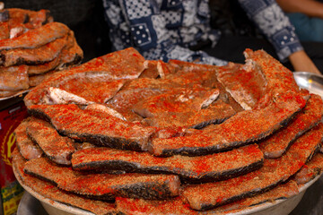A man of muslim religion selling a type of Rahu fish fry at Zakaria street at the time of Ramadan.