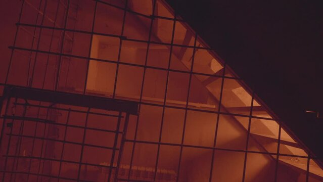 Empty jail cell. Prison. Horror or halloween concept. Orange electric light. Shadows. High quality FullHD footage