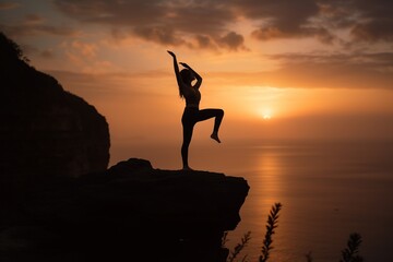 A young woman practicing yoga on a picturesque cliff overlooking the ocean during sunset, the silhouette of her body forming an elegant and balanced pose