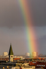 Copenhagen, Denmark A rainbow shines aboves the Vesterbro district and the Church of Christ, Kristkirken, spire.