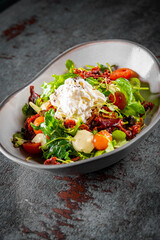 Sun dried tomatoes Salad with fresh vegetables mix and cheese on plate