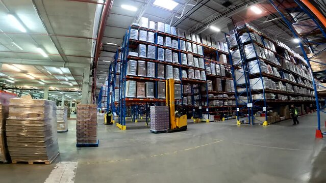Large modern warehouse timelapse. Workers work in the warehouse general plan time lapse. Workflow in a large warehouse