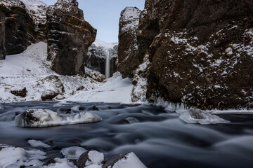 Fototapeta na wymiar Icelandic river with waterfall in the background