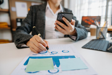  woman using tablet while sitting on cellphone at home. Beautiful girl relaxing while chatting on mobile phone at office