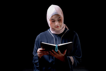 The image of an Asian Muslim woman in the Islamic religion in hijab in cream and black color....
