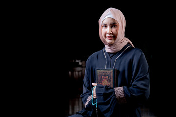 The image of an Asian Muslim woman in the Islamic religion in hijab in cream and black color....