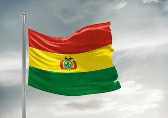 Bolivia national flag cloth fabric waving on beautiful sky Background.