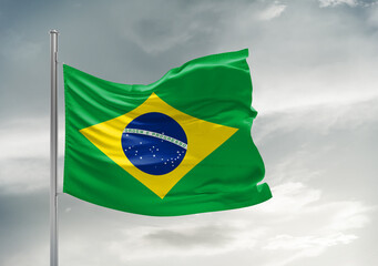 Brazil national flag cloth fabric waving on beautiful sky Background.