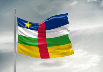 Central African Republic national flag cloth fabric waving on beautiful sky Background.