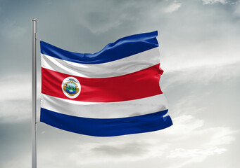 Costa Rica national flag cloth fabric waving on beautiful sky Background.