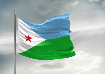 Djibouti national flag cloth fabric waving on beautiful sky Background.