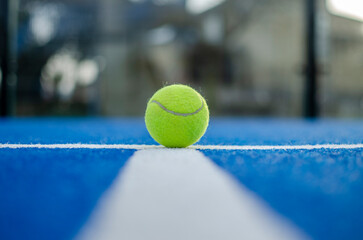 Bright blue tennis, paddle ball or pickleball court close up of service line outdoors. selective...
