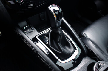 Fototapeta na wymiar Close up of the automatic gearbox lever, black interior car, Automatic transmission gearshift stick. Closeup a manual shift of modern car gear shifter.