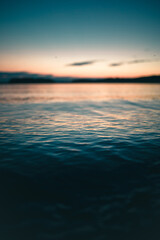 Obraz premium Beautiful landscape of dark deep water of the sea on the sunset