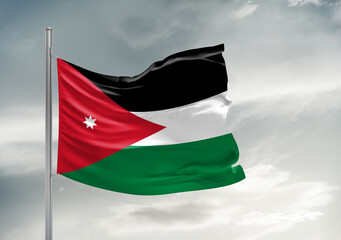 Jordan national flag cloth fabric waving on beautiful sky Background.