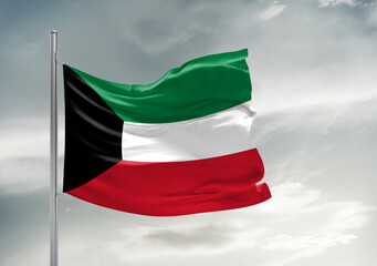 Kuwait national flag cloth fabric waving on beautiful sky Background.