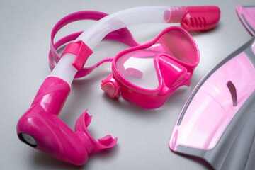 Children's mask, snorkel and pink fins for scuba diving.