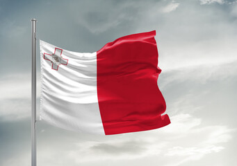 Naklejka na ściany i meble Malta national flag cloth fabric waving on beautiful sky Background.