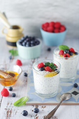 Greek yogurt in glasses with berries and quinoa