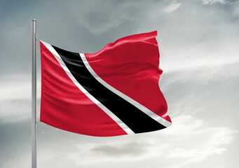 Naklejka na ściany i meble Trinidad and Tobago national flag cloth fabric waving on beautiful sky Background.