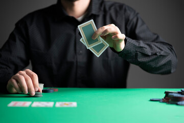 poker player in the casino playing a game and holding cards