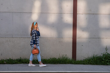 A young woman is walking down the street