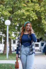 A young woman is walking down the street