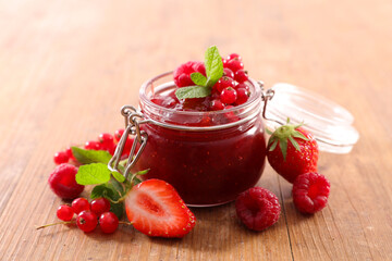 berries fruits jam in jar and fresh fruit