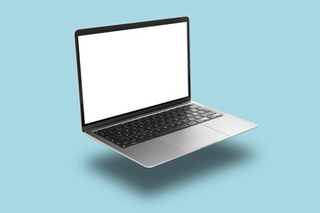 Modern laptop flying on light blue background