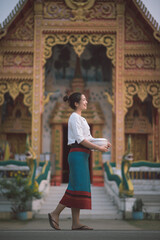 Songkran day with women in traditional Thai dress.